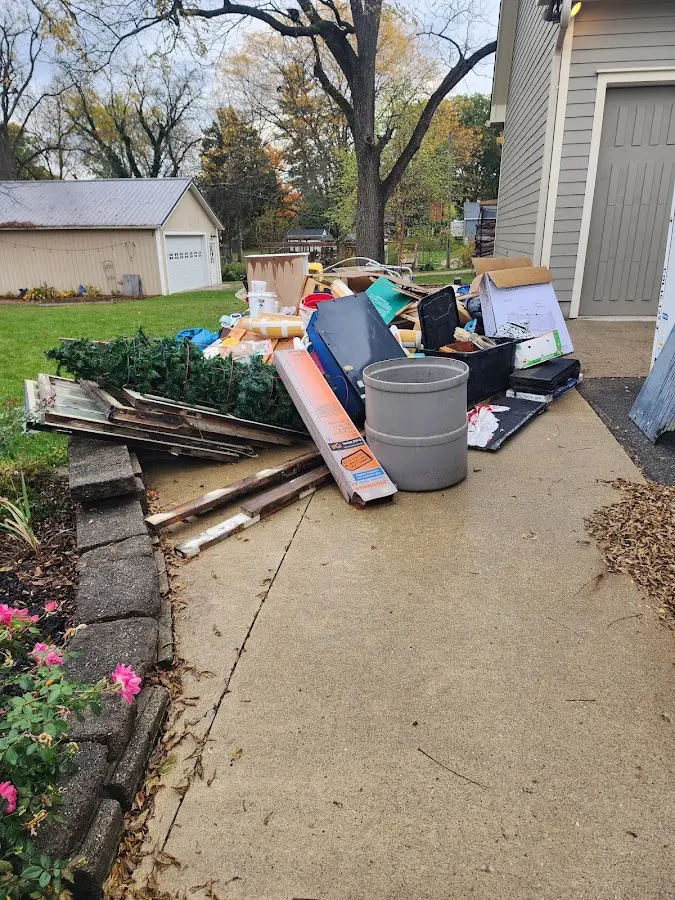 Dumpster being loaded with debris for Estate Cleanout Dumpster Rental in Cedar Creek